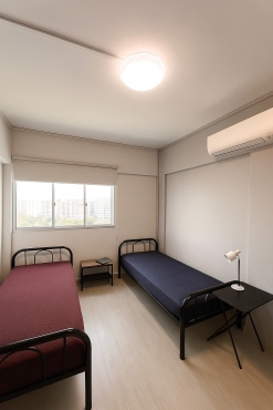 Common room with wall mount aircon and stand fan