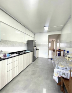 Common room with wall mount aircon and stand fan